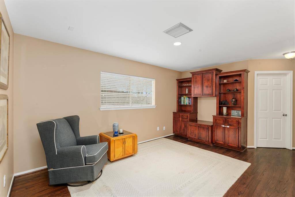 Upstairs, the game room features built-in cabinets for extra storage space.