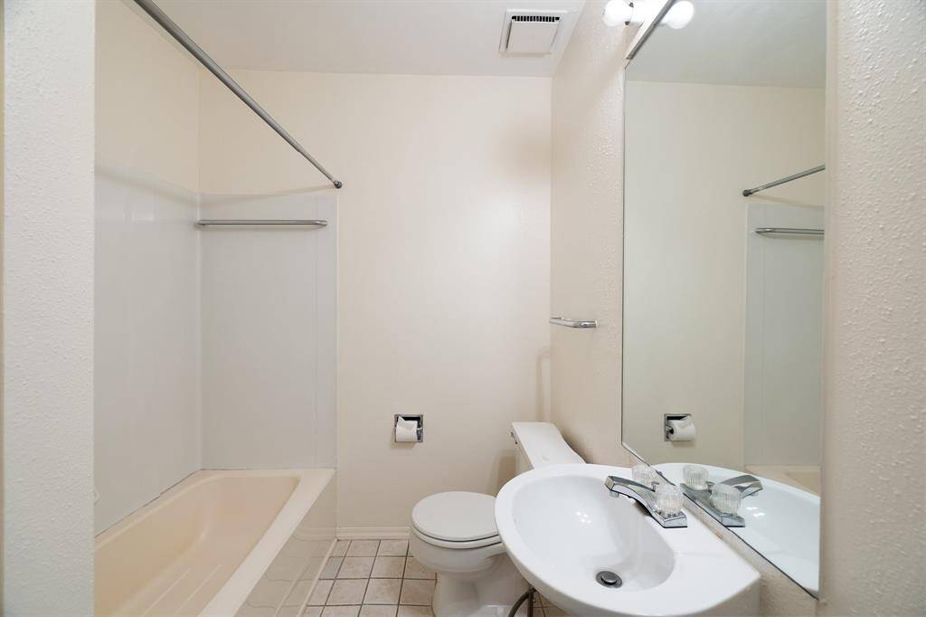 Secondary bath has a shower/tub combo.