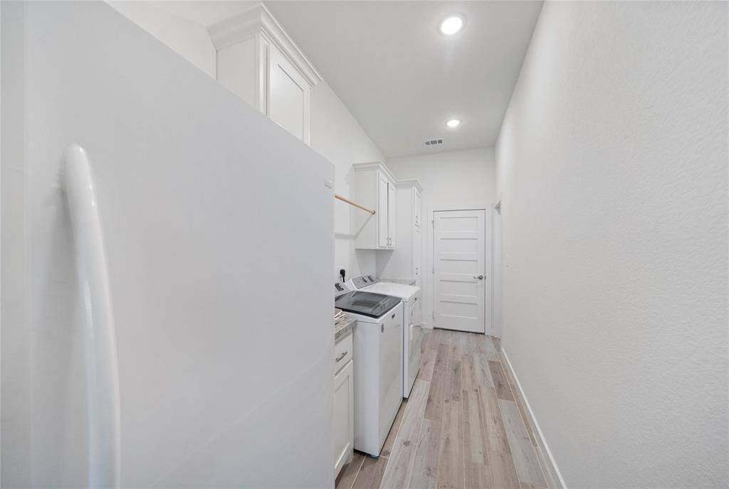 Large utility room has extra cabinets, and room for a second fridge as shown here.