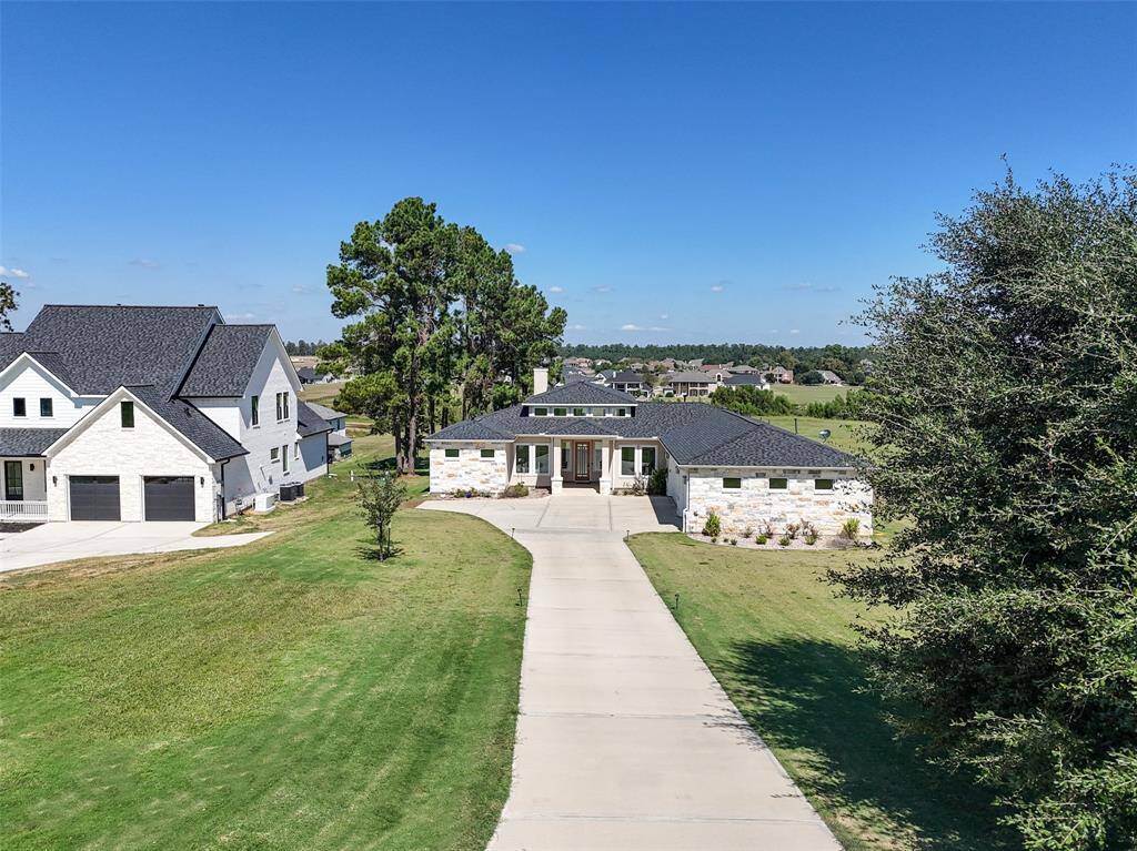 Aerial view of the front of the home taken from a little further up the driveway.