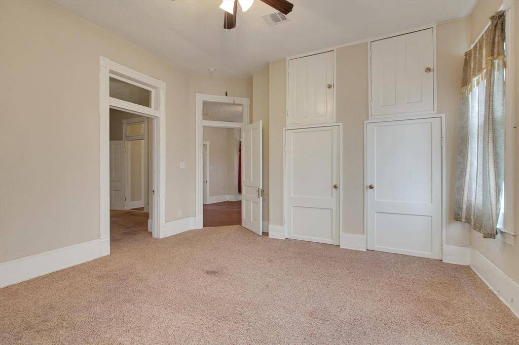 2nd floor bedroom. Check out those transom windows and high ceilings!