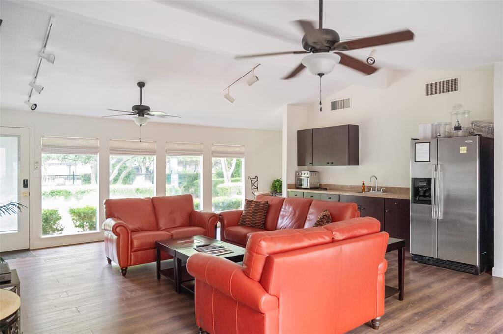 Clubhouse featuring a kitchenette and multiple TVs