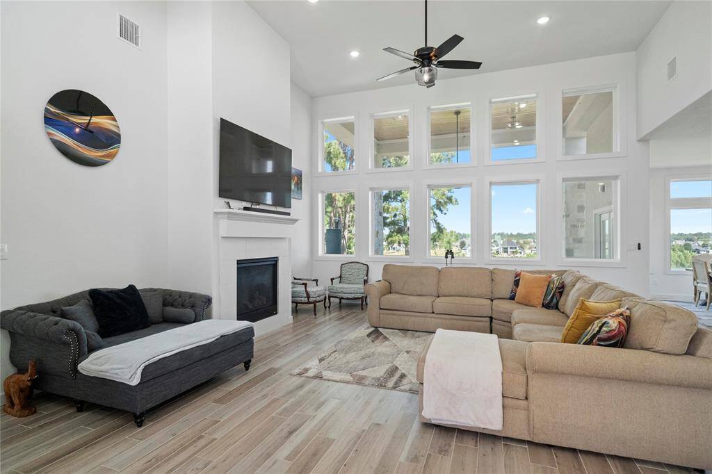 Open living room with high ceilings and lots of windows allow plenty of natural light, as well as providing great views out to the back of the property.