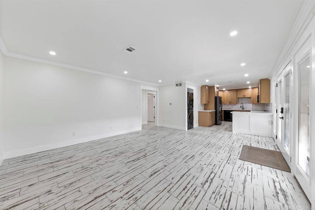 The kitchen opens to the living area, creating a spacious and inviting environment perfect for entertaining and everyday living.