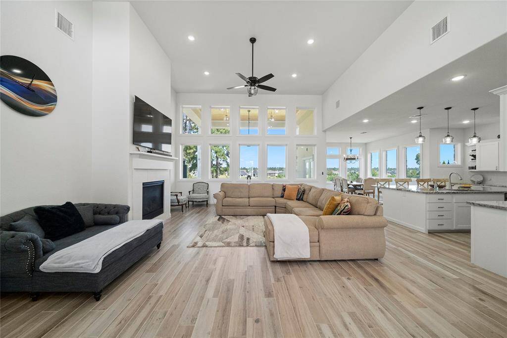 One more look at the living area taken from the entryway. Wood plank tile is here and throughout the entire home.