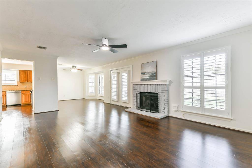 From this vantage point in the family room you can see that the living space spills into a flex-use dining area or study adjacent to the kitchen. Notice the abundance of windows dressed with timeless plantation shutters.