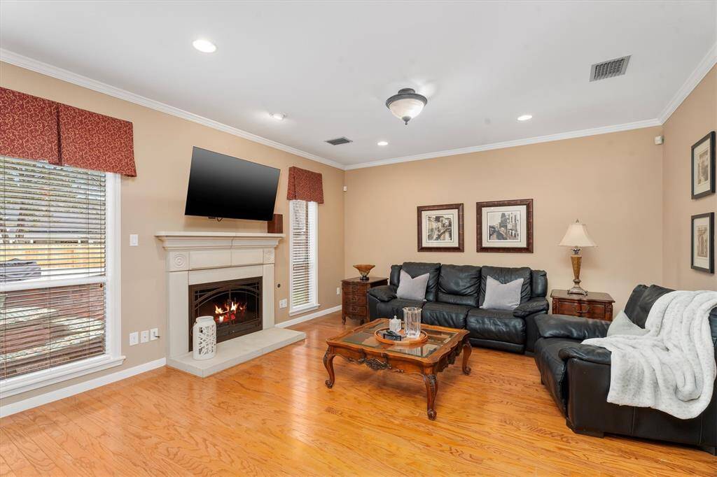 Recessed lighting and large windows provide plenty of natural light in the living room.