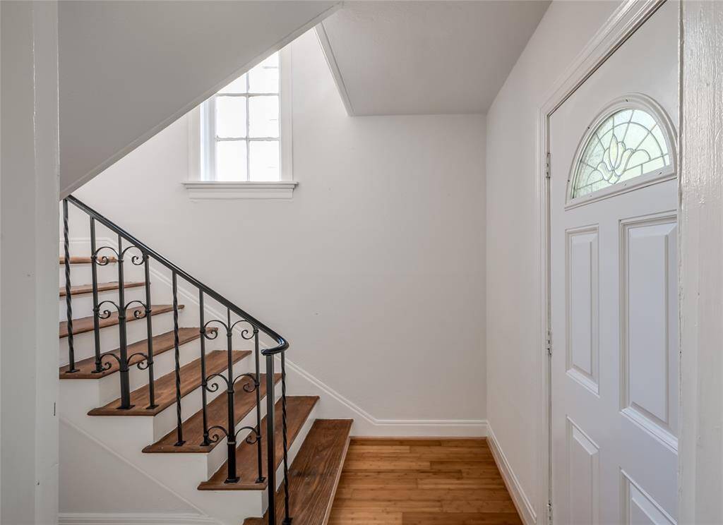 Recently refinished hardwood stairs at the inside front entrance. There are also back entrances for each unit.