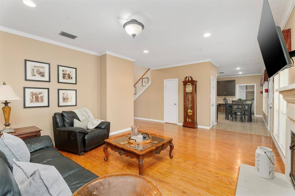 The open layout extends to a dining area and kitchen, enhancing flow and functionality.