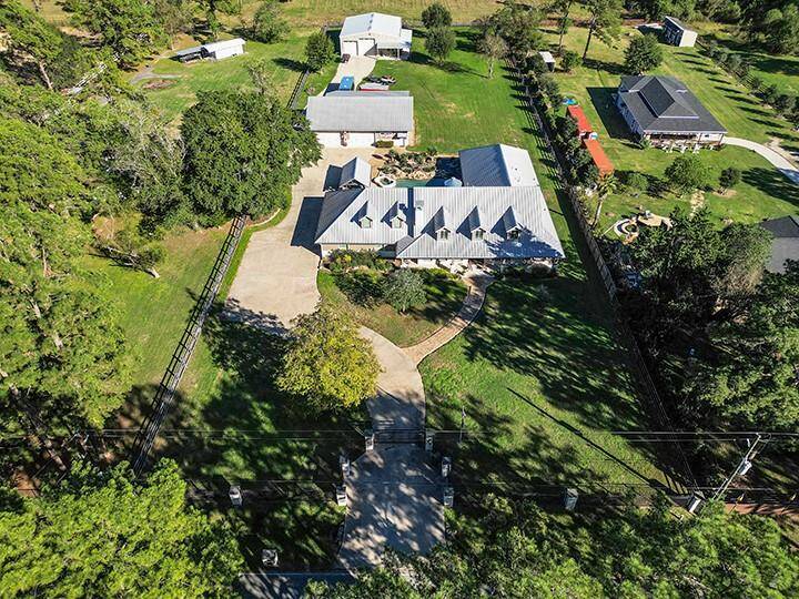 Rare 1.5 story home plus large workshop and barndominium with guest quarters on almost 2 acres, zoned to highly sought after Tomball ISD schools