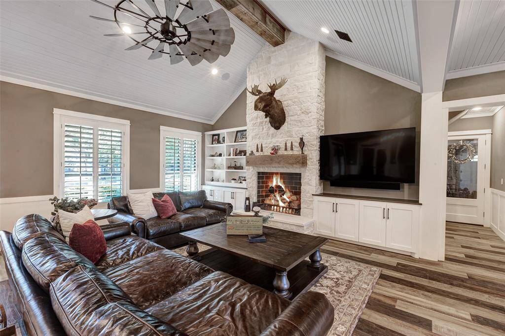 The wood ceilings, artful ceiling fan and beam detail add an unexpected designer finishing touch.