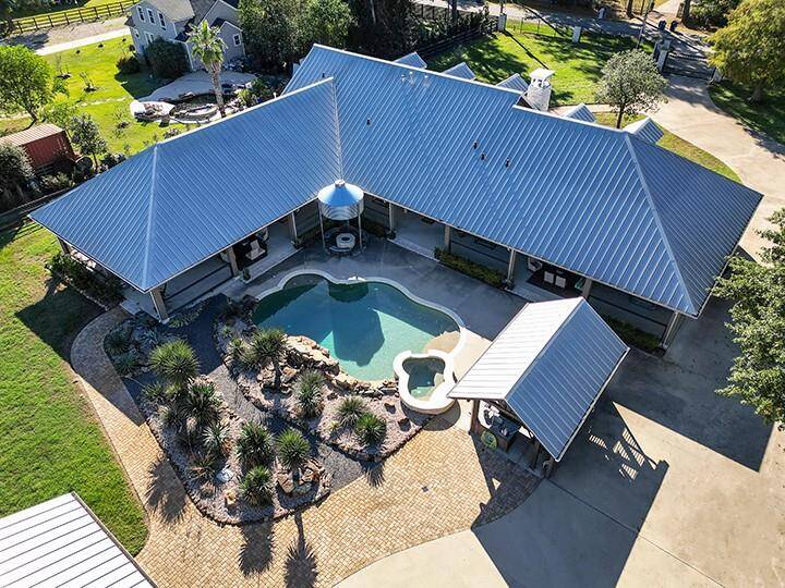 Centrally located resort style pool & spa surrounded by extensive covered porch