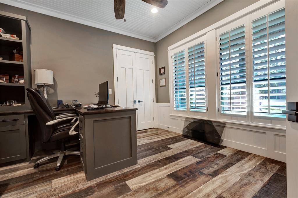 The home office/study has a built in desk and shelving with full light double doors for privacy