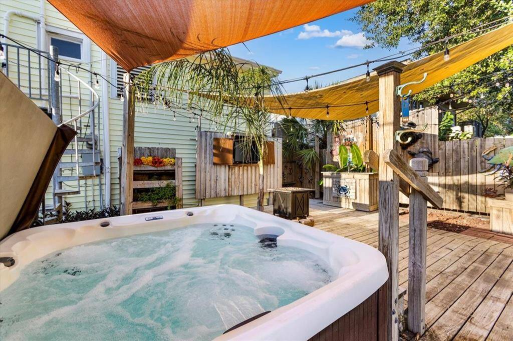 FABULOUS outdoor entertaining area! Hot tub, TV, bar, and deck all for your pleasure!