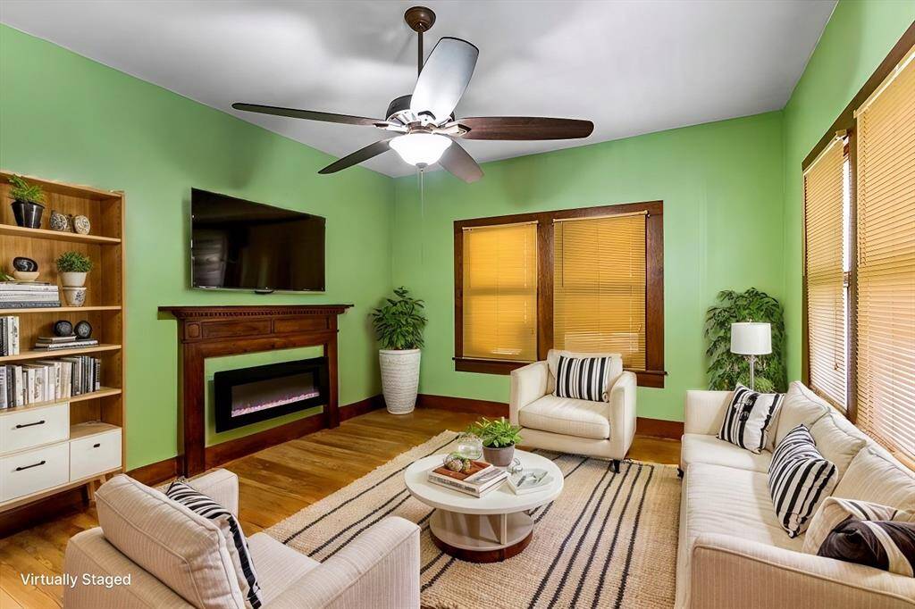 Virtually staged upstairs living room with high ceilings! Electric fireplace conveys with house