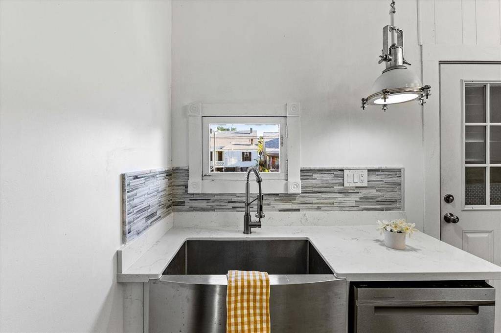 Window view from the Stainless Steel Apron Sink with ss dishwasher and nautical light fixture!
