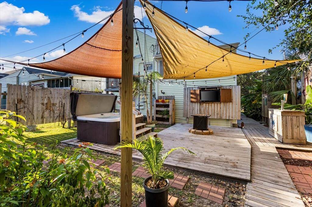 Back yard OASIS! Deck, bar, TV, hot tub, already landscaped and ready to serve your needs!