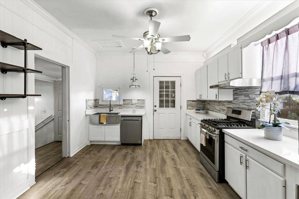 Upstairs Kitchen is light, bright, plenty of natural light with QUARTZ counter tops, Stainless steel appliances, and TWO bonus wine fridges!