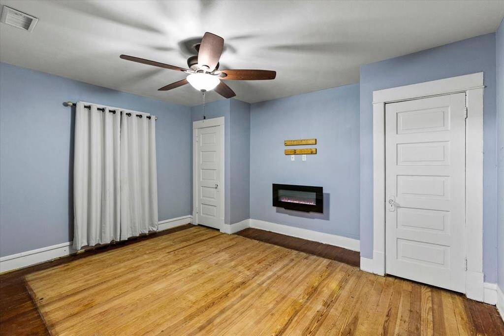 Upstairs Bedroom #1- Primary bedroom with electric fireplace heater