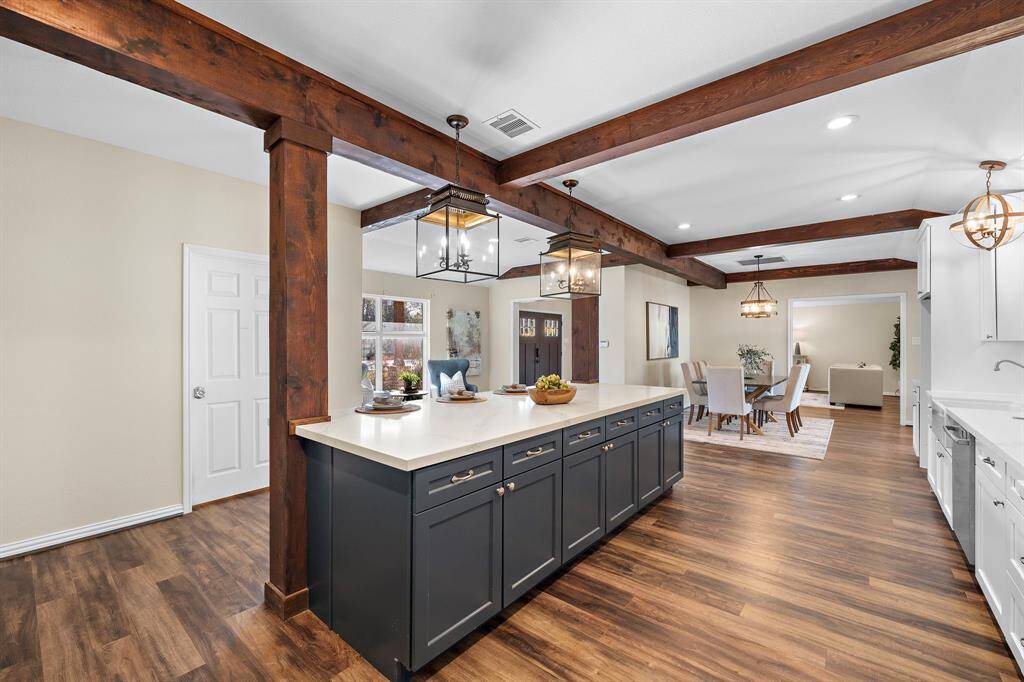 Notice the gorgeous wood beams and custom lighting fixtures.