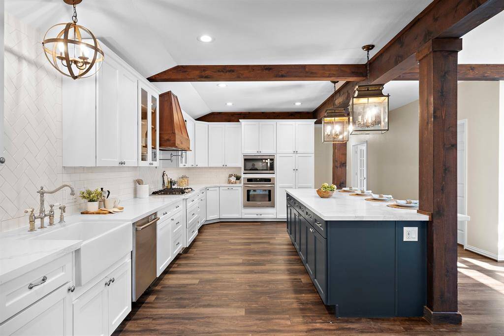 The kitchen features quartz countertops, stainless steel appliances, soft close cabinets and drawers, a pot filler, and pots and pans drawers.