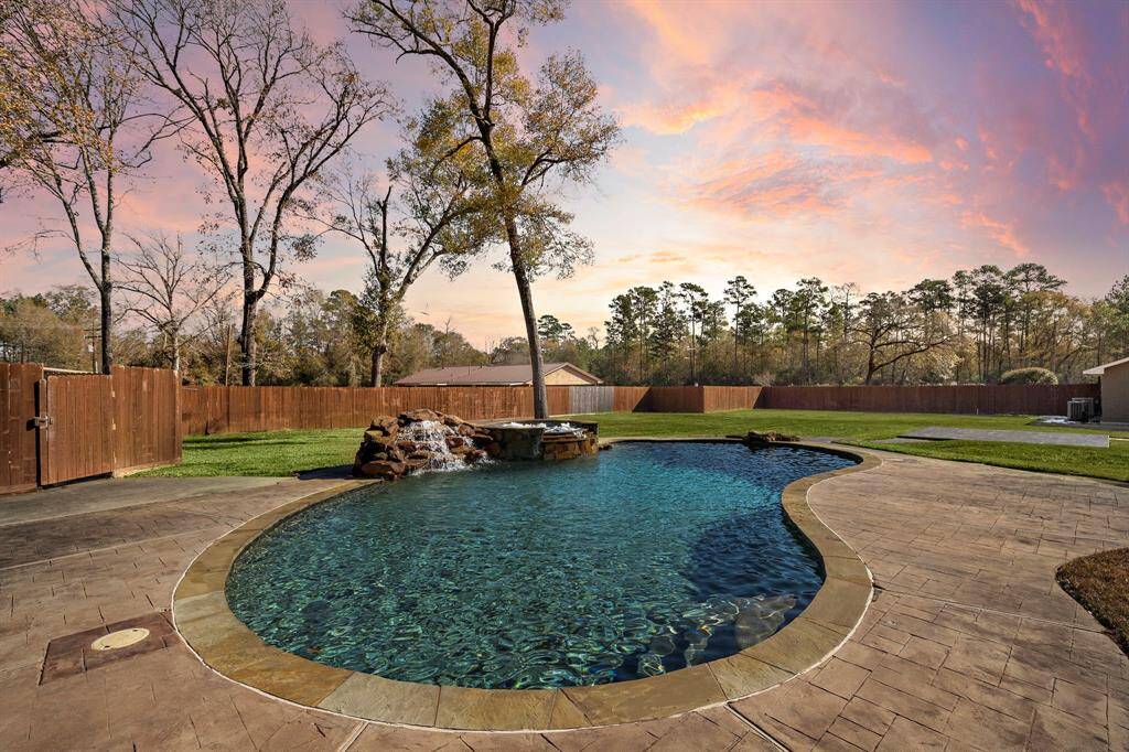 Stunning pool and spa with waterfall features.