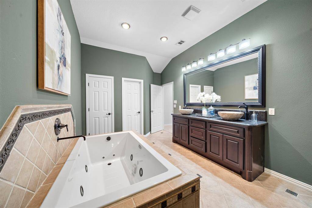 The bathroom also features an oversized jetted soaking tub.