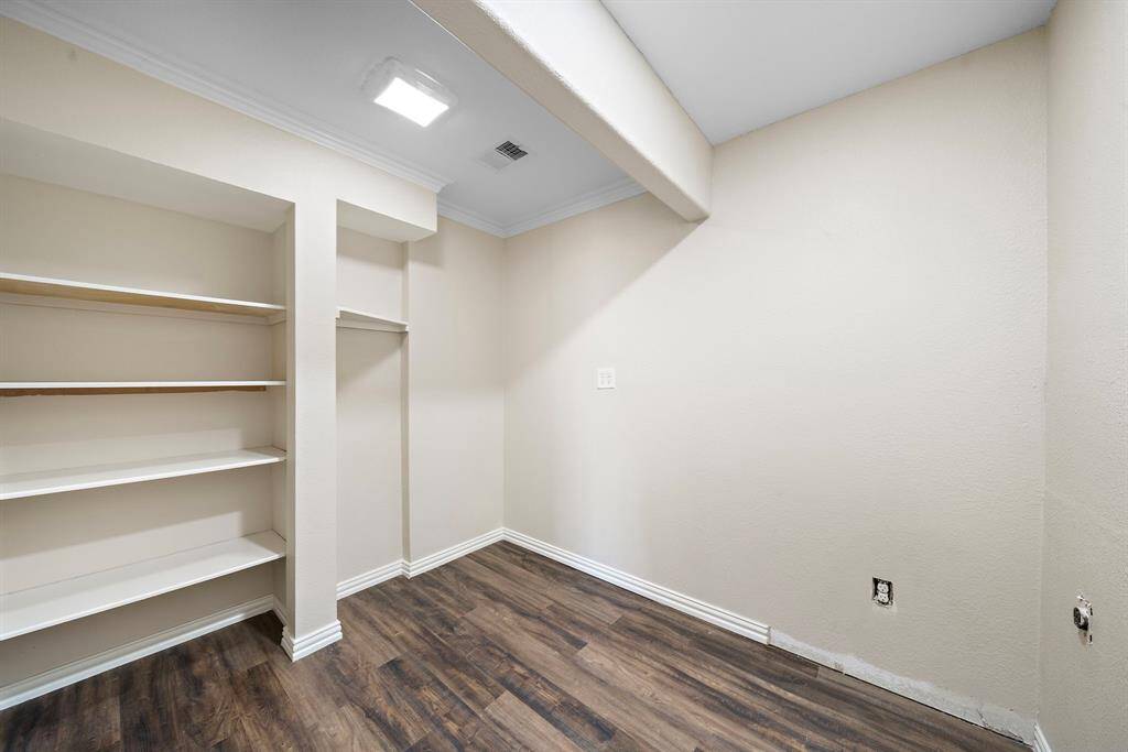 Laundry room that is located in the hallway that leads to the primary bedroom.