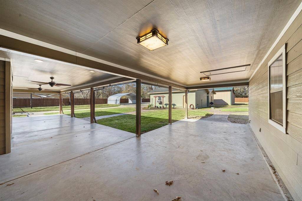 Large L shaped covered patio off the back of the home.