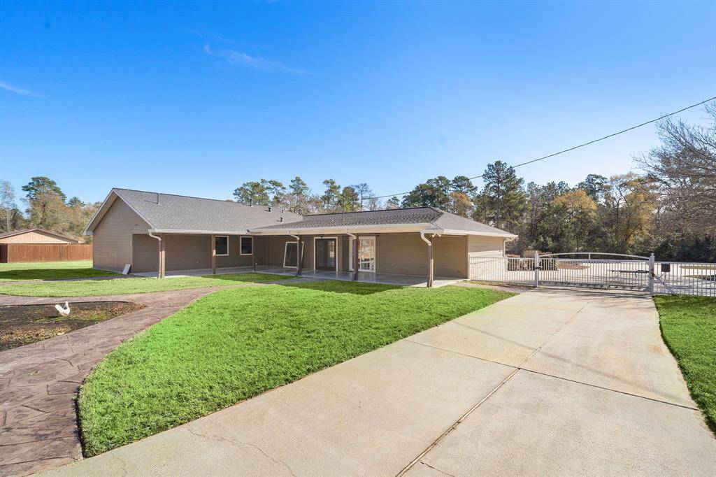 Another view of the back of the home and the driveway gate.