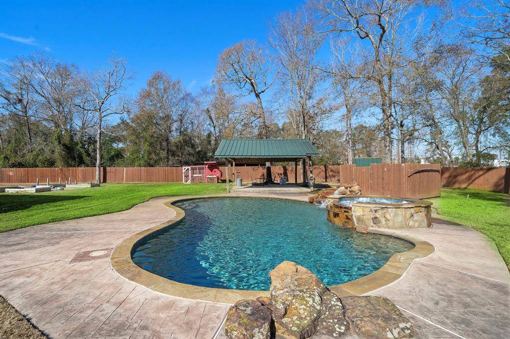 Gunite pool and spa featuring a water fall feature.  Also a 2nd outdoor covered patio located off the back of the pool.