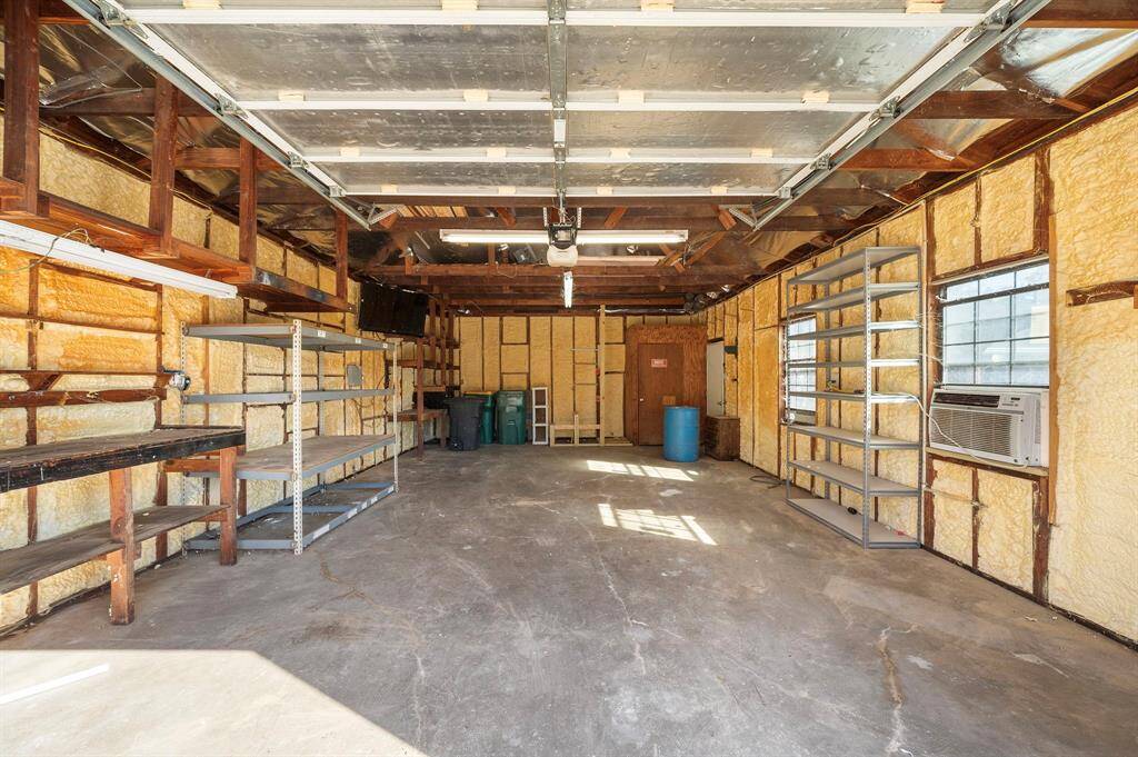 The first outbuilding is a double wide garage and has been used in the past as a workshop.  It is also air conditioned and has insulation to keep it cool during the summer months.