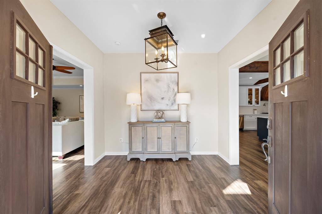 Gorgeous foyer area featuring luxury vinyl plank flooring and a chandelier.