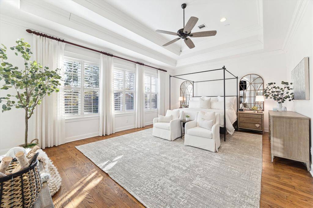 A sanctuary of comfort and luxury, the primary suite includes a spacious bedroom, a private sitting area, and a lavish en-suite bathroom with a soaking tub, dual vanities, and a walk-in shower.