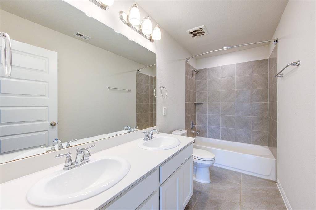 Secondary bath with double sinks.