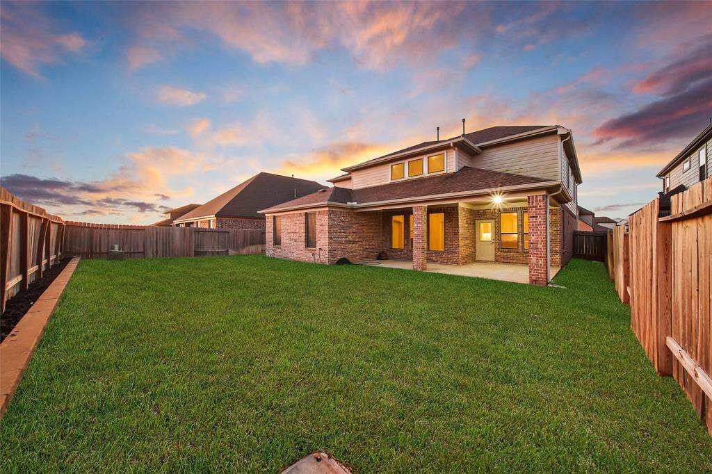 Spacious, fenced backyard complete with large covered patio.