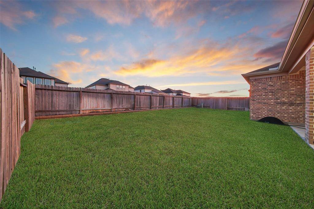 Spacious, fenced backyard complete with large covered patio.