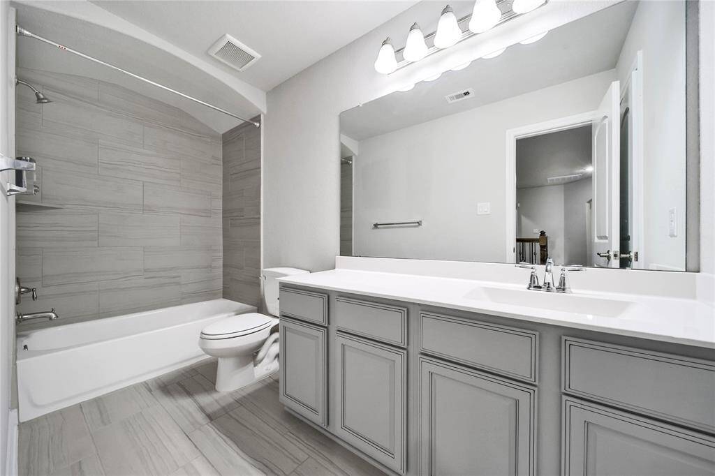 Third full bathroom conveniently located upstairs between bedroom four and five.