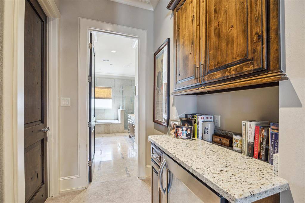 Just off of the primary, this area could be used as a coffee bar and has an under-counter refrigerator installed