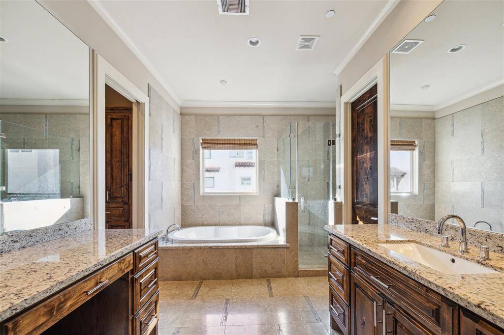 Primary bath has a soaking tub and separate shower.  Note the vanity with knee space.