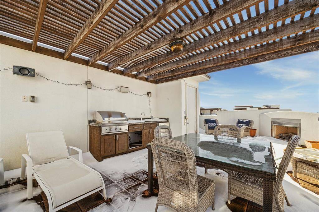 The fifth floor roof deck offers an outdoor kitchen under the pergola