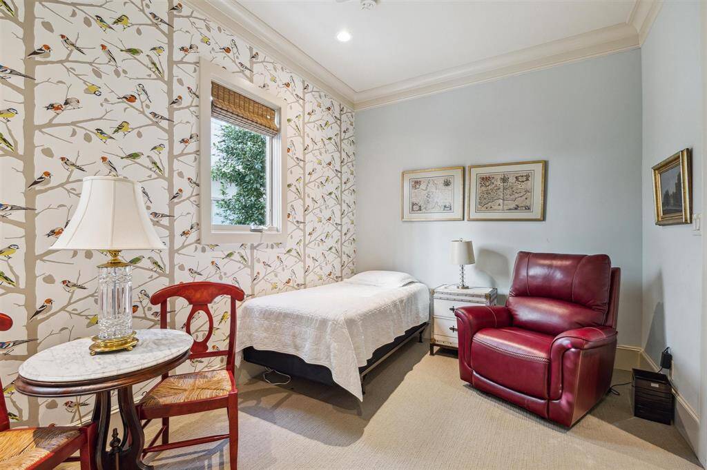 Charming paper brightens the first floor bedroom with its en-suite bathroom.