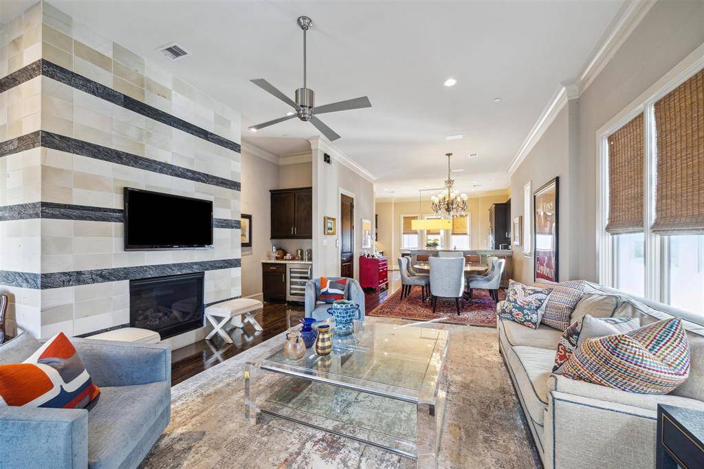 The second floor offers chic open-concept living with soaring 11' ceilings and tons of natural light.