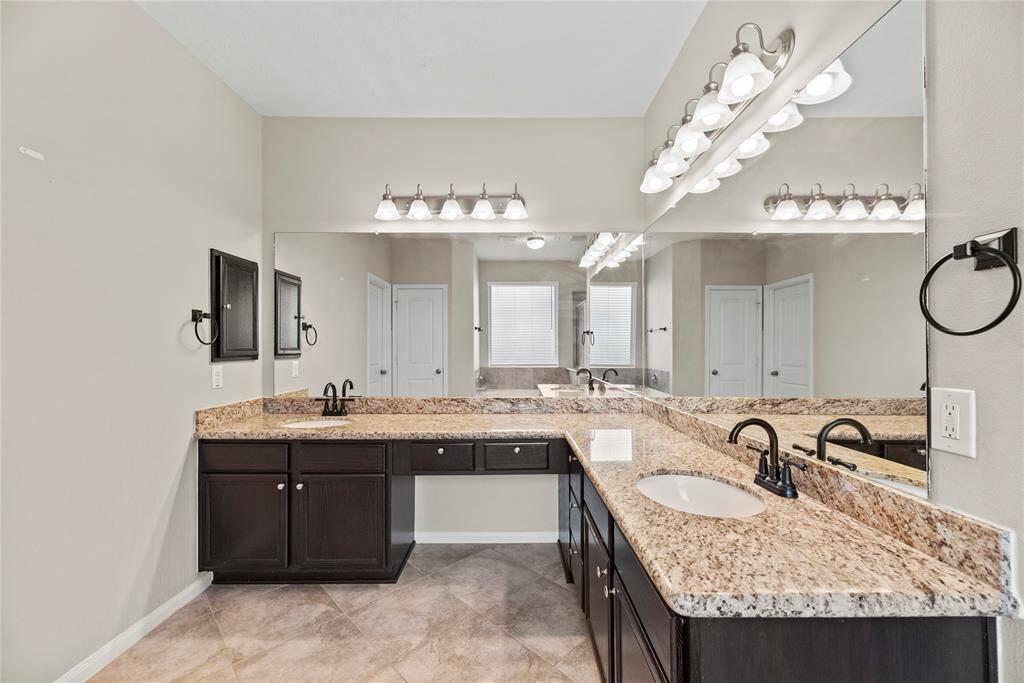 The large primary bath is spa-like with its walk-in closet, deep soaking tub, double sinks, vanity area, and walk-in shower with granite counter tops. Top of the line creates the luxury and elegance you deserve. Make every day a spa day here.