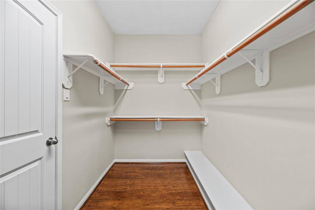 The primary closet offers ample space to store all your clothes and keep everything organized.