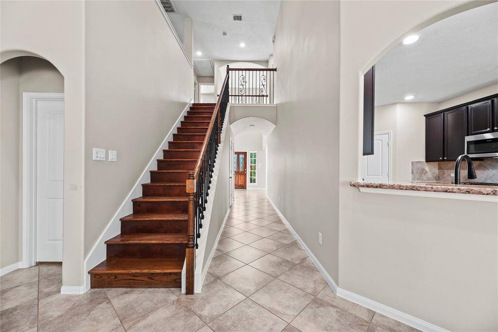 The beauty of the natural wood staircase catches your eye. Let's see what the second floor holds.