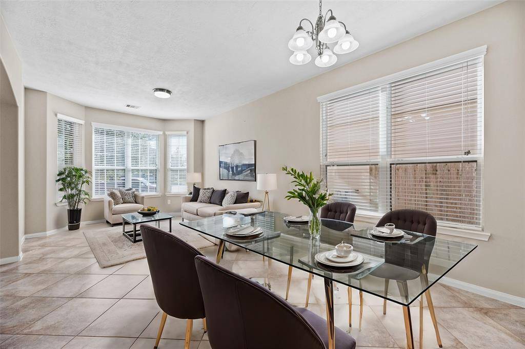 Natural lighting and neutral walls complete the stunning look of this inviting dining space and formal living space. The dining room opens to the left of the entryway, leading to the kitchen, making the flow for entertaining effortless. Gather here and start creating lasting memories.