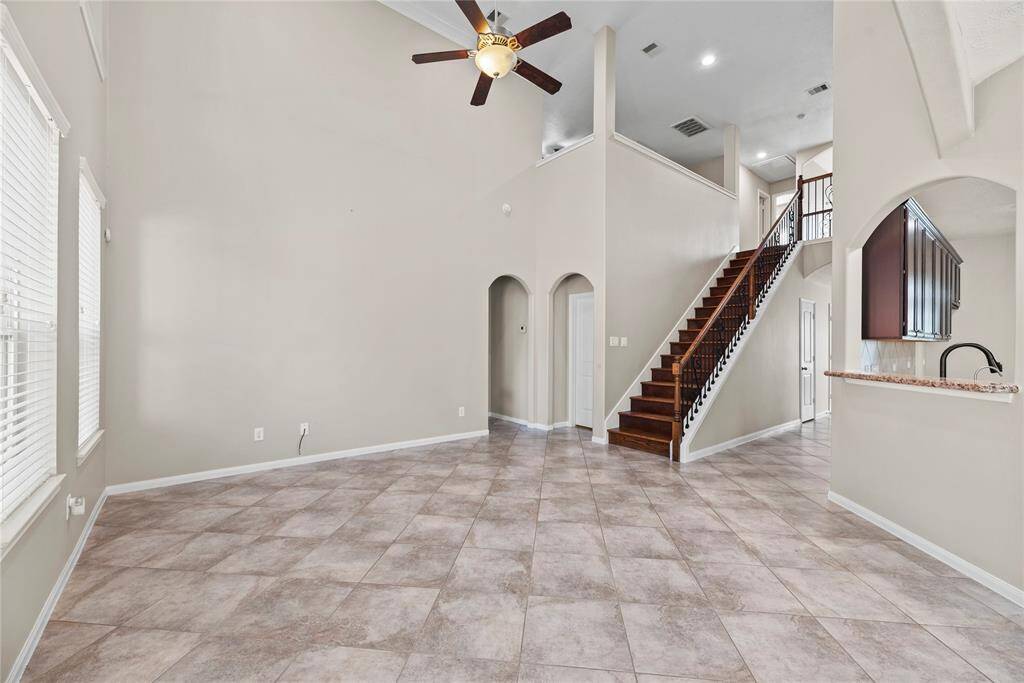 Soaring space connects your living space to the upstairs. Open sight lines create seamless flow. Versatility meets visual drama in this dual-level design. This space is beautiful.