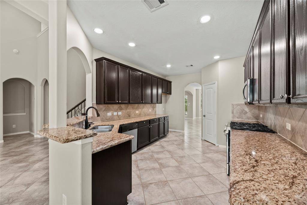 A happy home always has a happy kitchen. Fun, inspiring & tons of room to move around! Plenty of cabinet storage to keep all your gadgets tucked away and the counters clean!