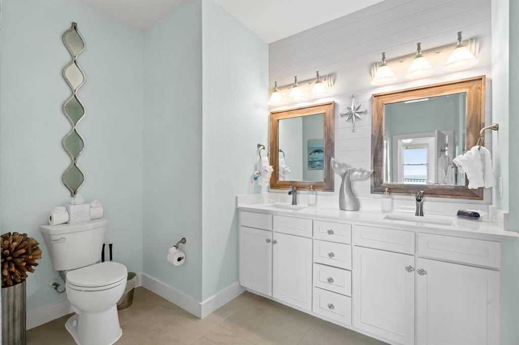 "Beachy chic" primary bathroom with SHIPLAP accent wall, quartz counter tops, designer decor!